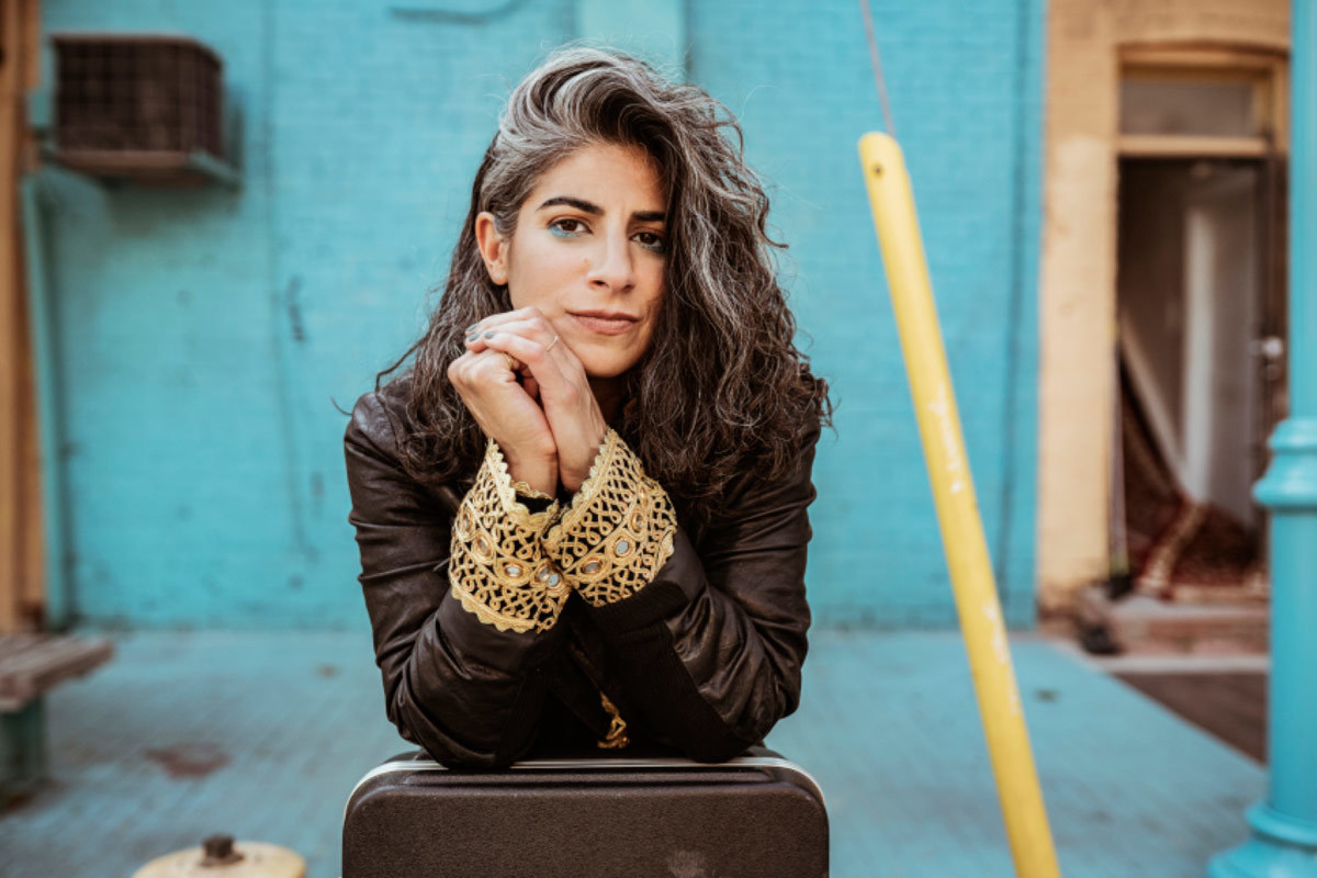 Danielle Duval in front of a blue wall